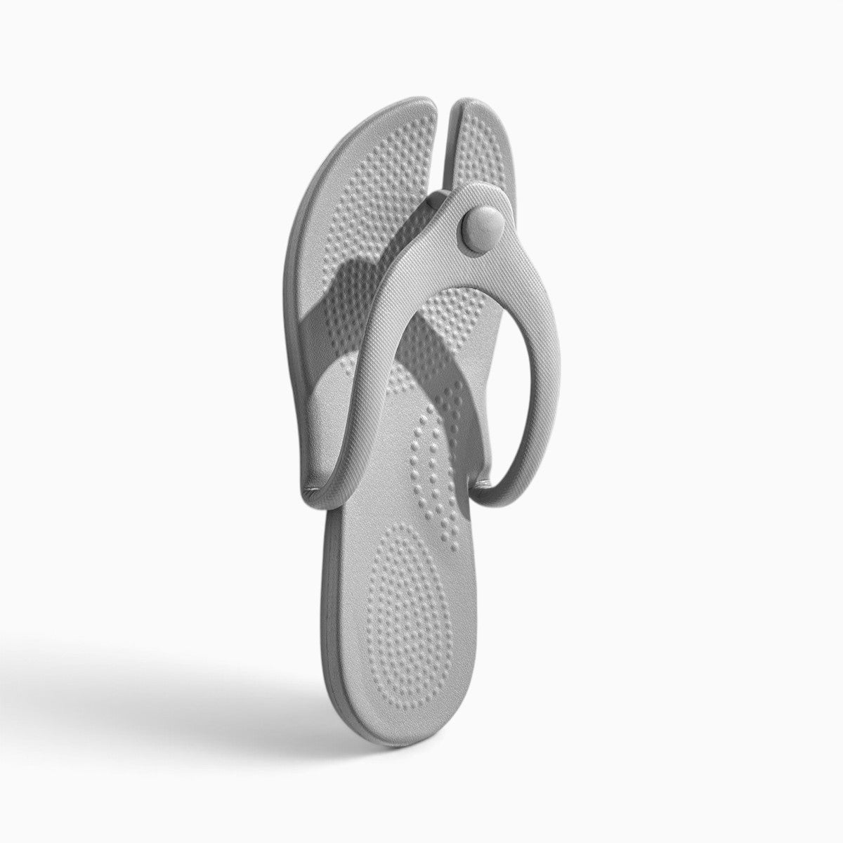 Tong pliable grise NOMADYS par Orthopodys, marque exploitée par AIIBORI (SASU), en EVA léger pour le voyage.